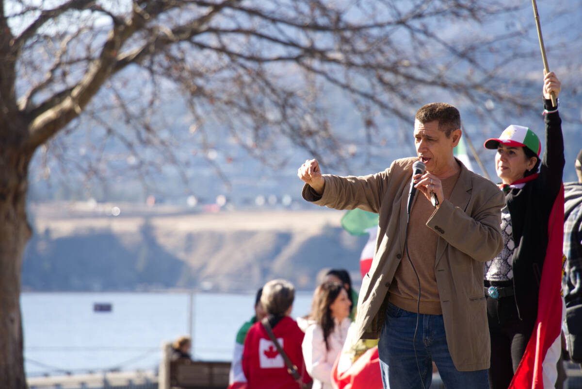 UBC Okanagan professor Ray Taheri speaking to a crowd in Kelowna on March 1 regarding the American-Israeli strikes on Iran. (Ty Lim/Kelowna Capital News)