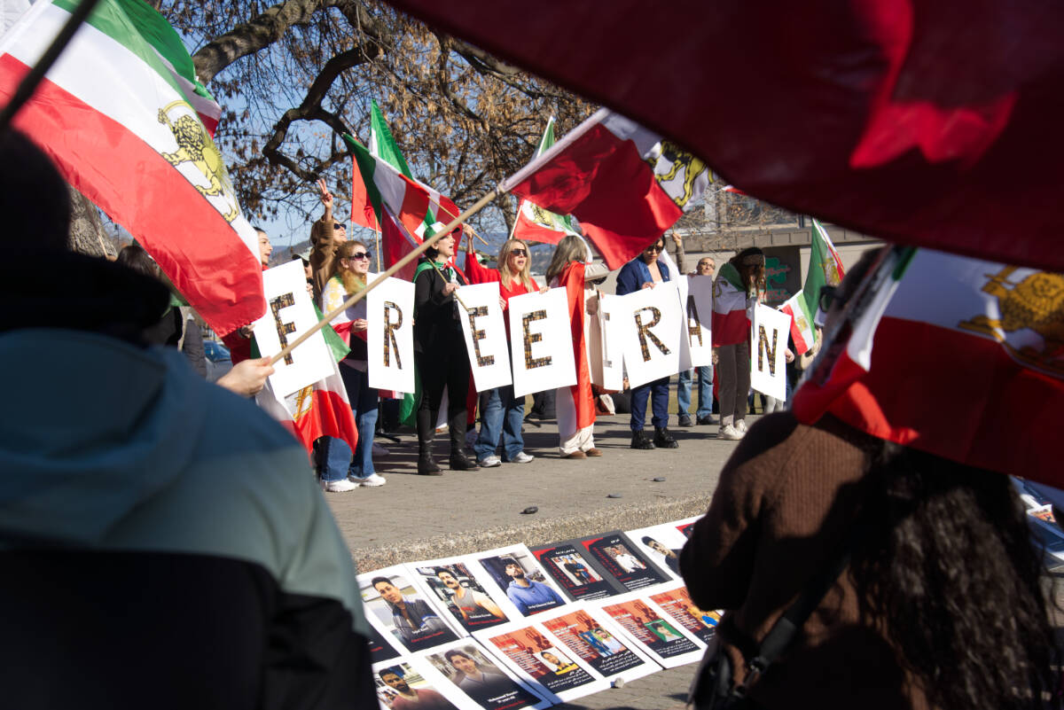 People at gathering for Iran in Kelowna on March 1 holding signs that reads &ldquo;free Iran&rdquo;. (Ty Lim/Kelowna Capital News)